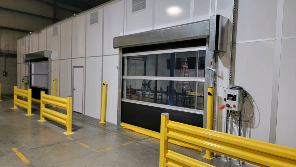 Roll-up doors on modular metrology lab enclosures by MachinEnclosure