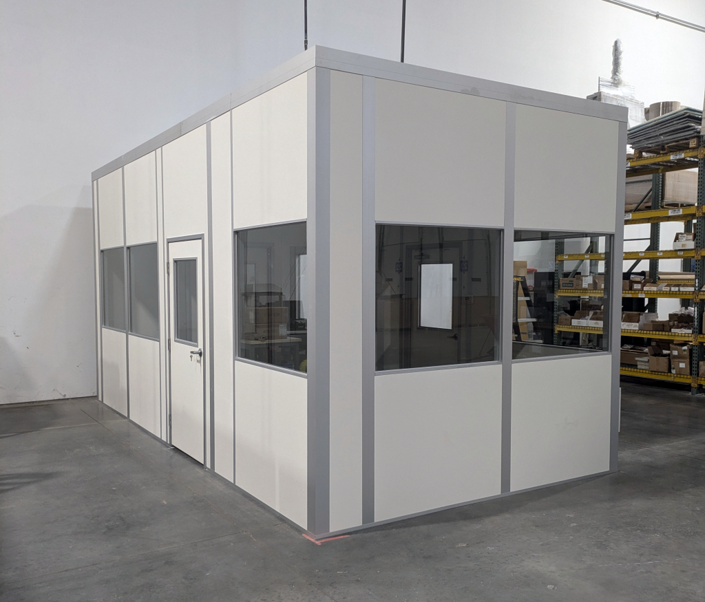 Modular laser engraving machine enclosure by MachineEnclosure.com installed in an industrial facility.