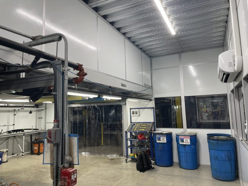 Custom indoor equipment shelters by MachineEnclosure.com with industrial workspace integration.