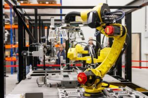 Industrial robotic arm on a manufacturing floor without a safety enclosure