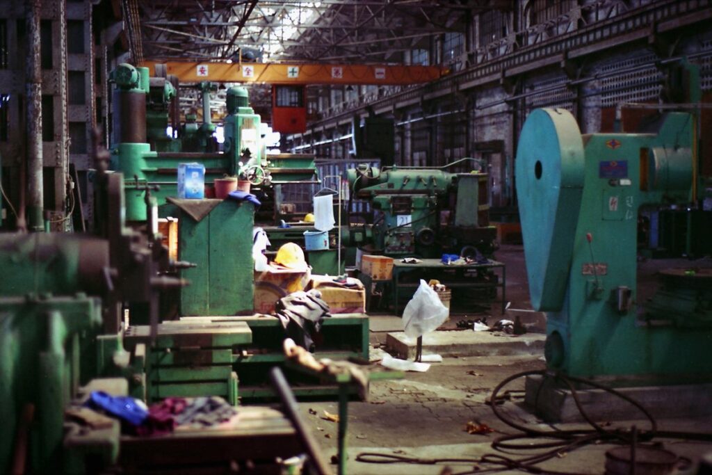 Crowded factory floor with heavy machinery and no noise reduction measures